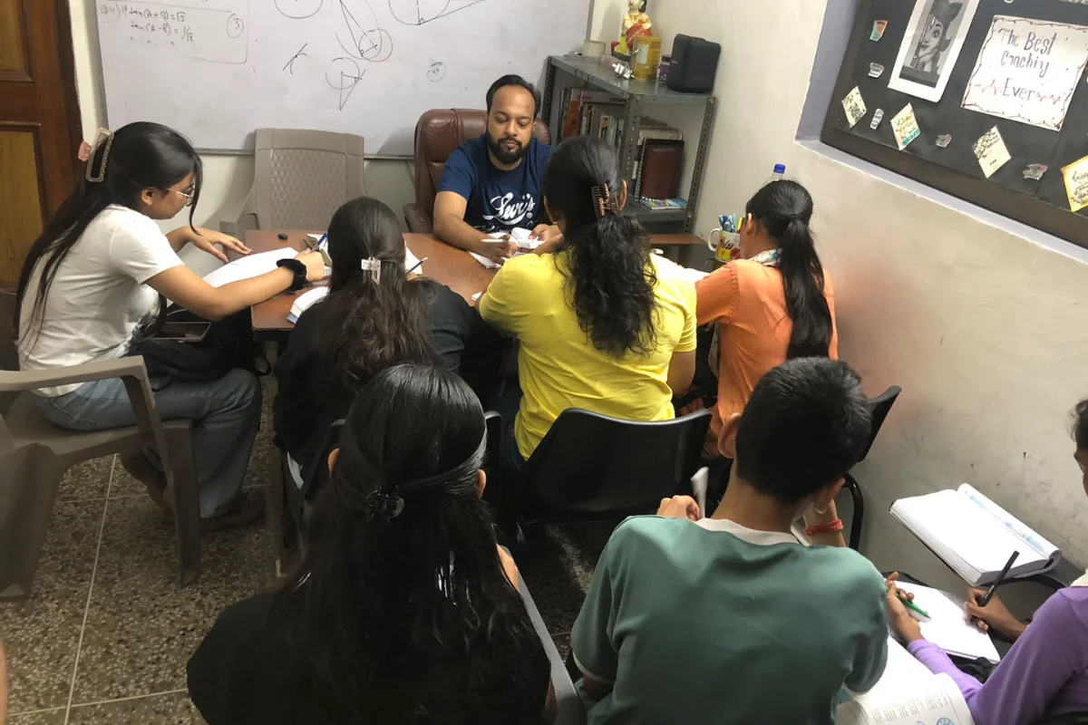 Dhairya Sir teaching a small group of students at Nipun Coaching